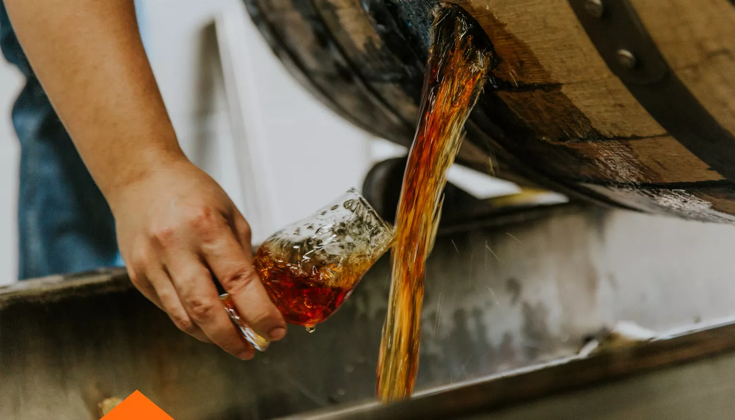 bourbon pouring out of a barrel