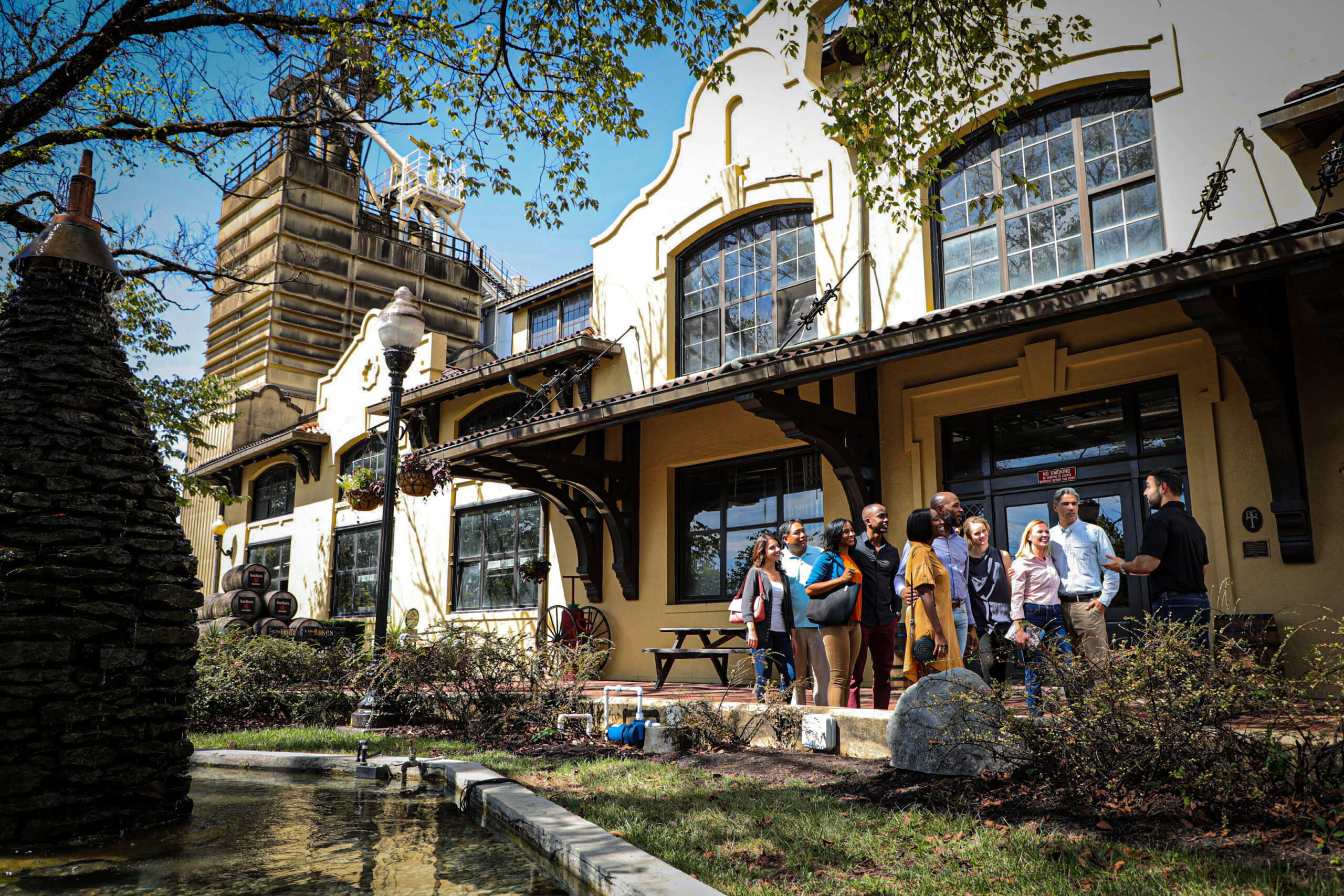 Visitors to the Kentucky Bourbon Trail® stand outside Four Roses Distillery